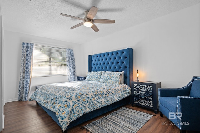 bedroom with a textured ceiling, dark hardwood / wood-style flooring, and ceiling fan