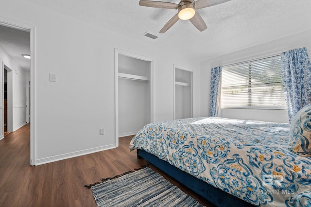 bedroom with dark hardwood / wood-style flooring, a textured ceiling, a closet, and ceiling fan