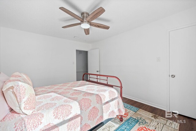 bedroom with ceiling fan and dark wood-type flooring