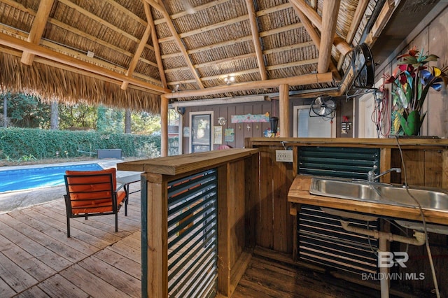 wooden deck with a gazebo and an outdoor bar