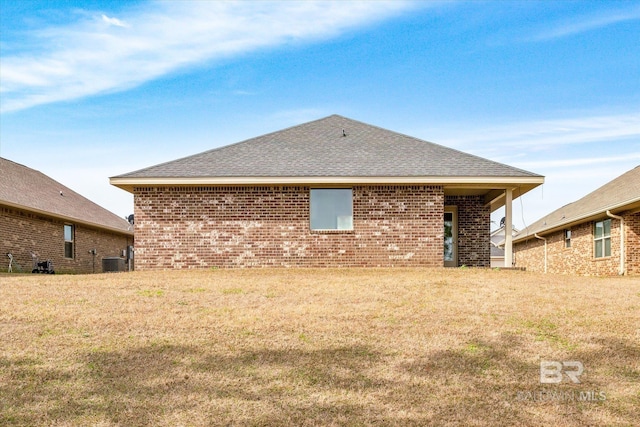 back of house with a lawn and cooling unit