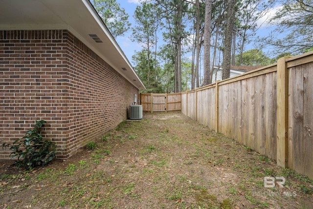 view of yard featuring central AC and a fenced backyard