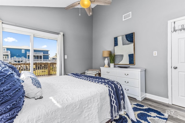 bedroom with ceiling fan, visible vents, baseboards, vaulted ceiling, and light wood finished floors