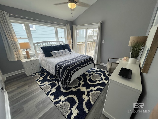 bedroom featuring access to exterior, lofted ceiling, dark wood-type flooring, and baseboards