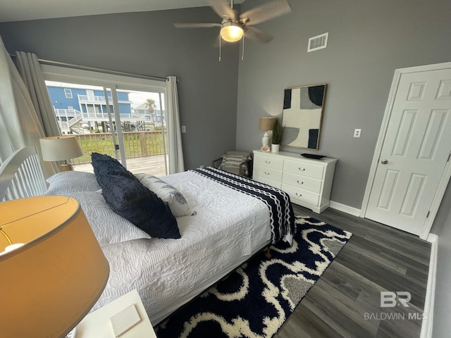 bedroom with lofted ceiling, visible vents, baseboards, access to outside, and dark wood finished floors