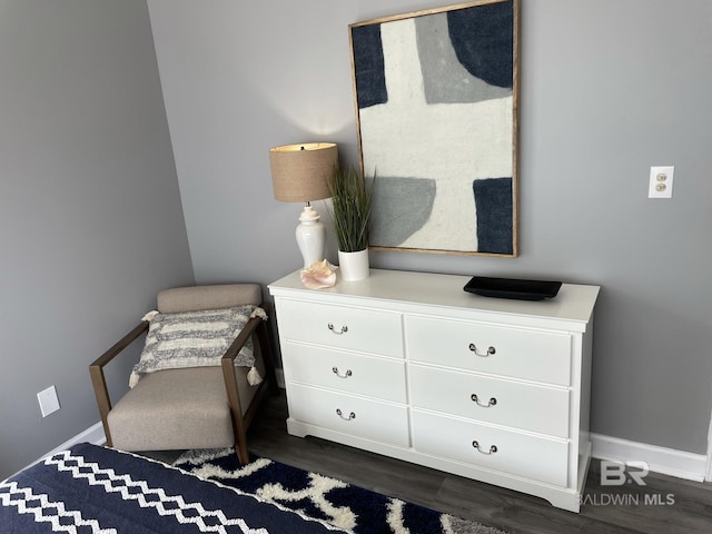 bedroom featuring baseboards and dark wood-style flooring