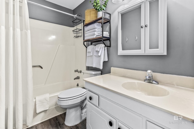 full bath with vanity, wood finished floors, shower / bath combo with shower curtain, and toilet