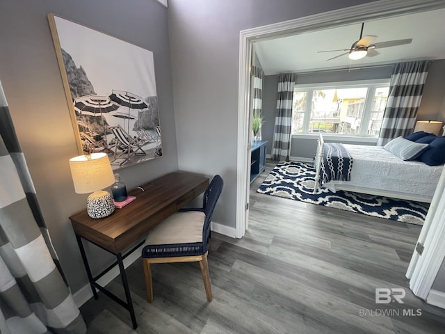 bedroom with baseboards and wood finished floors