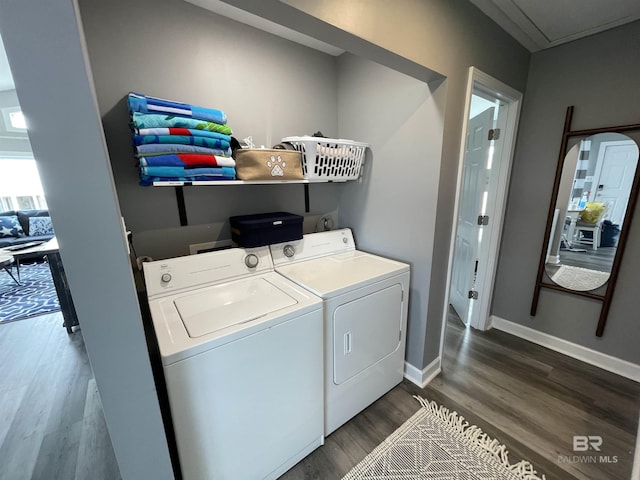 washroom featuring washing machine and dryer, dark wood-style flooring, baseboards, and laundry area