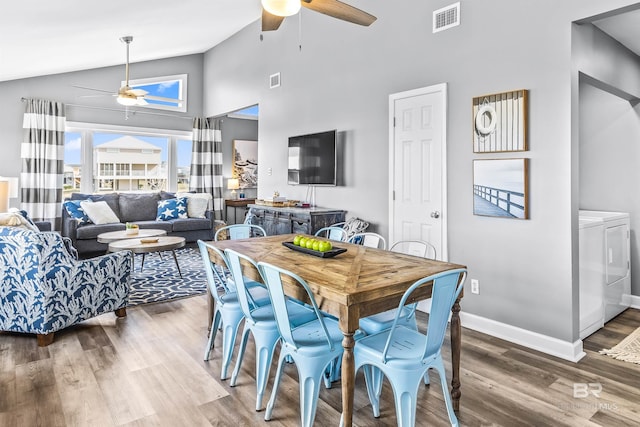 dining area featuring baseboards, visible vents, a ceiling fan, wood finished floors, and independent washer and dryer