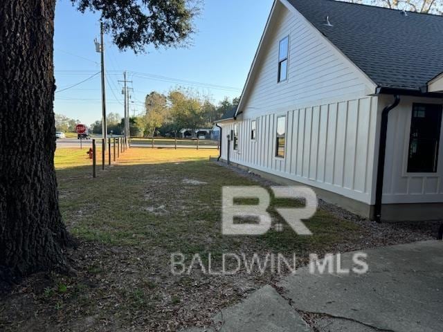 view of side of property with a lawn