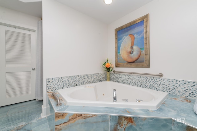 bathroom featuring tiled bath and tile patterned flooring