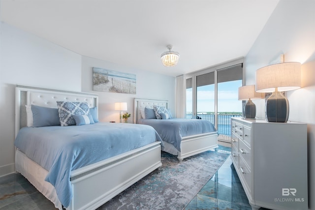 bedroom featuring access to outside and a wall of windows