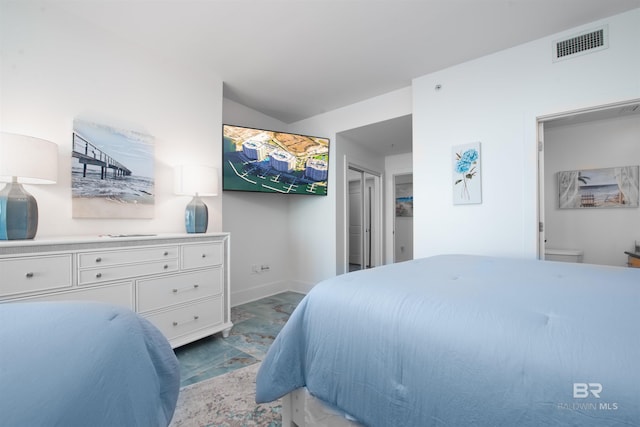 bedroom with lofted ceiling, a closet, and connected bathroom