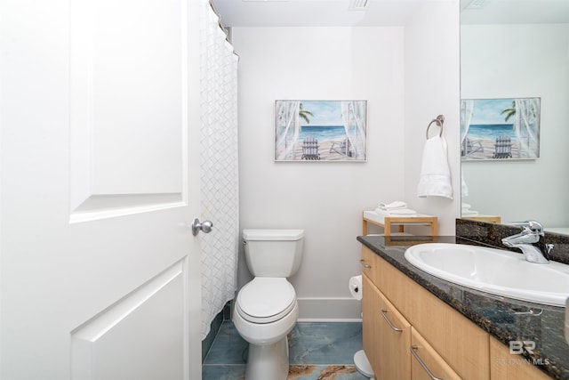 bathroom featuring vanity and toilet