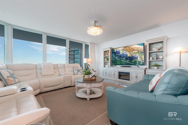 living room with a fireplace and expansive windows