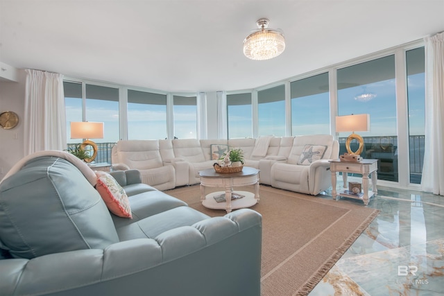 living room featuring floor to ceiling windows and a water view