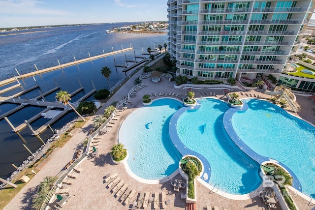 view of pool with a patio and a water view