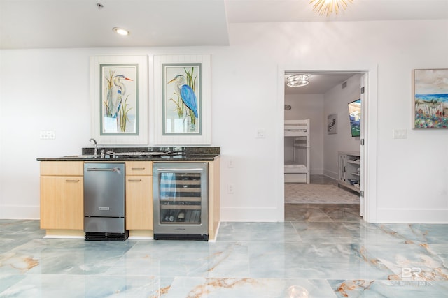 bar featuring sink, light brown cabinets, and wine cooler