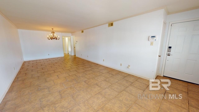 spare room featuring an inviting chandelier