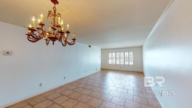 spare room featuring light tile patterned floors, a notable chandelier, and ornamental molding