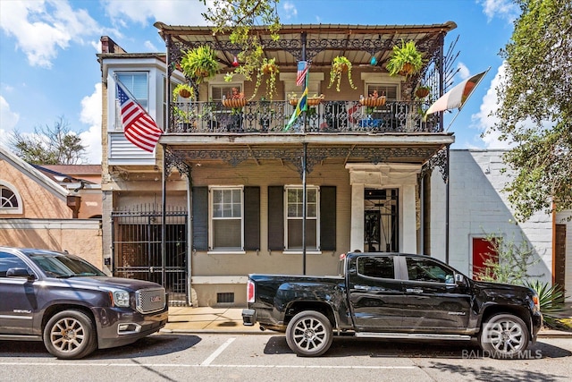 view of front of home with a balcony