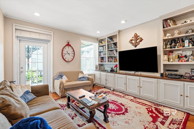 living room with light hardwood / wood-style floors and built in features