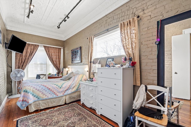 51 N Jackson St Unit A, Mobile, AL 36602 - bedroom with rail lighting, wood finished floors, multiple windows, and brick wall