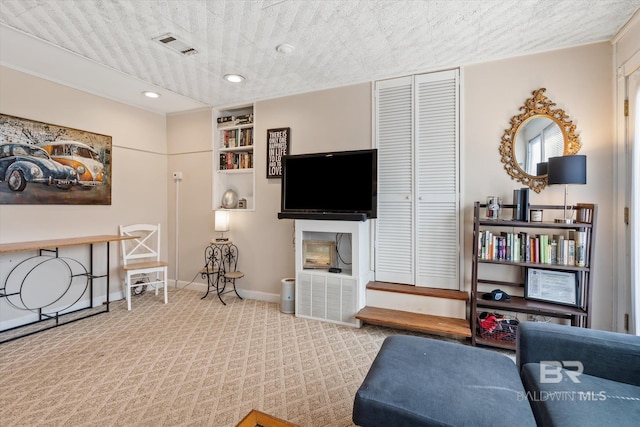 living room with light carpet and a textured ceiling