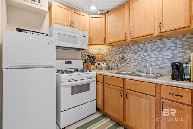 kitchen featuring backsplash, white appliances, light brown cabinets, and sink