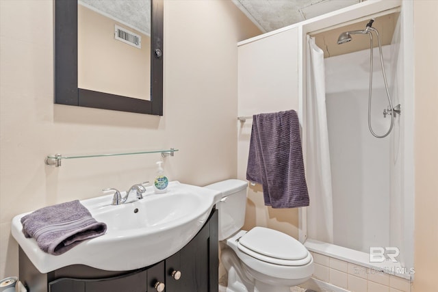 bathroom featuring toilet, vanity, and a shower with shower curtain