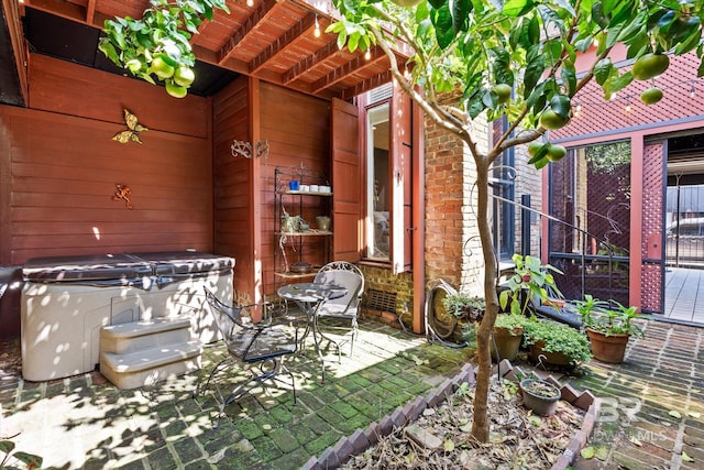 view of patio / terrace with a hot tub