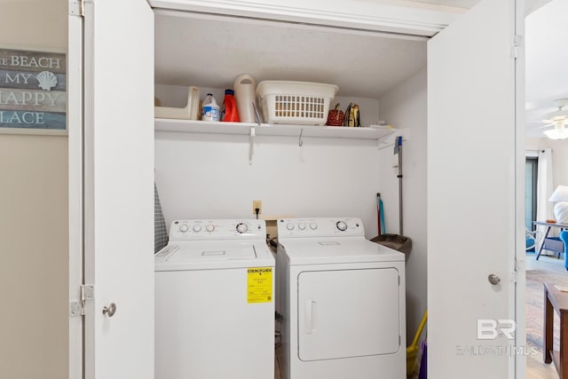 clothes washing area with a ceiling fan, independent washer and dryer, and laundry area