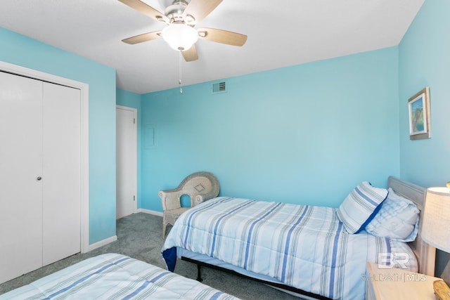 carpeted bedroom featuring a closet, baseboards, visible vents, and ceiling fan