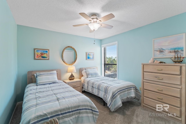 bedroom with carpet, baseboards, and a textured ceiling