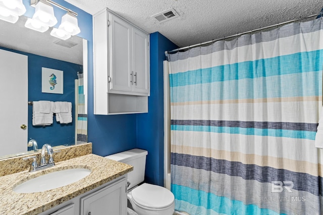 bathroom with visible vents, a textured ceiling, vanity, and toilet