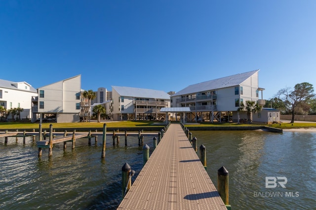 dock area with a residential view and a water view