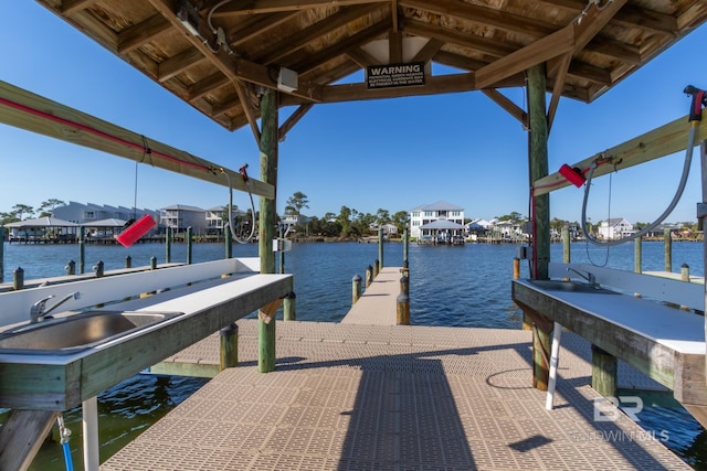 view of dock featuring a sink, a water view, and boat lift