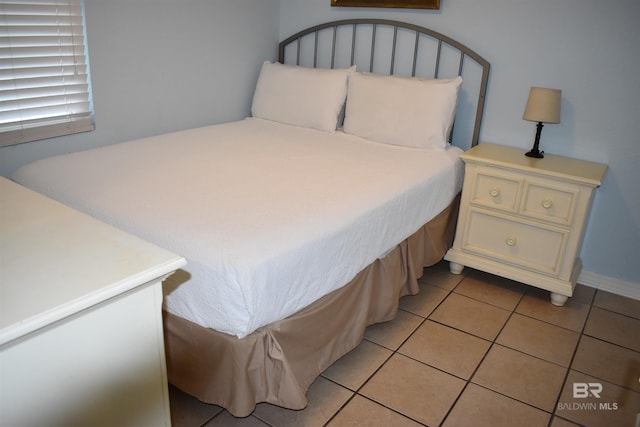 bedroom with light tile patterned flooring