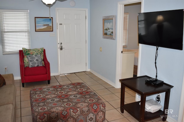 interior space with ceiling fan and light tile patterned floors