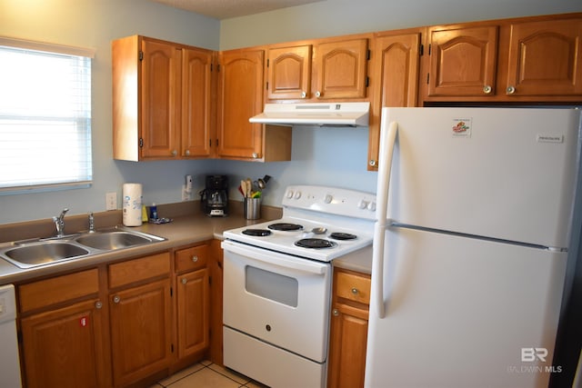 kitchen featuring white appliances, light tile patterned flooring, and sink