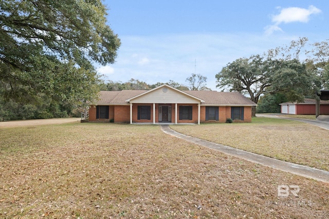 ranch-style home featuring a porch and a front yard