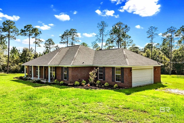 view of front of house with a garage, a front lawn, and covered porch