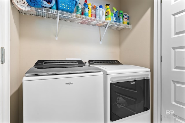 laundry room featuring washing machine and clothes dryer and laundry area