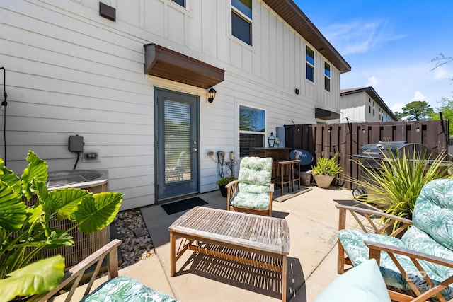 view of patio / terrace featuring outdoor lounge area, central air condition unit, and fence