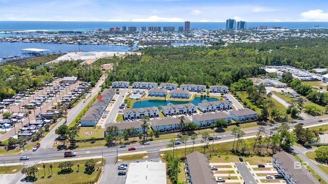 drone / aerial view featuring a city view and a water view