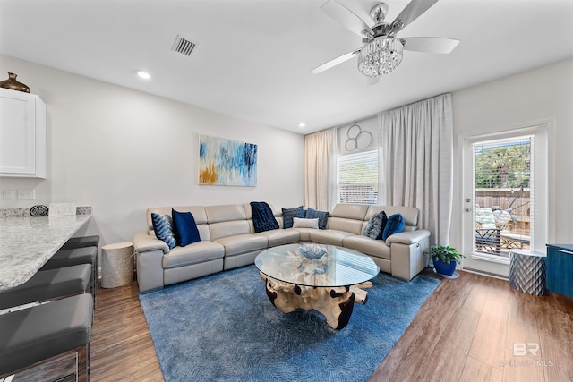 living room featuring wood finished floors, visible vents, recessed lighting, and ceiling fan