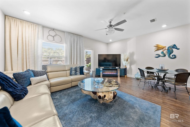 living area with recessed lighting, wood finished floors, visible vents, baseboards, and ceiling fan