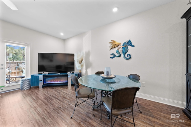 dining space featuring baseboards, dark wood-type flooring, and recessed lighting