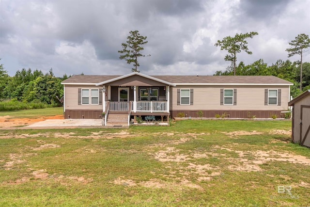 11691 Grantham Rd, Foley, AL 36535 - manufactured / mobile home featuring a front lawn, covered porch, and a patio area